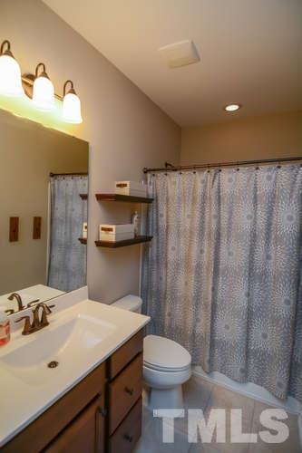 720 Wickham Ridge Road Apex, NC 27539 - Photo 9 of 21 The master bath is finished with ceramic tile floor, tile surround in the tub/shower, a cabinet vanity and a walk-in closet.