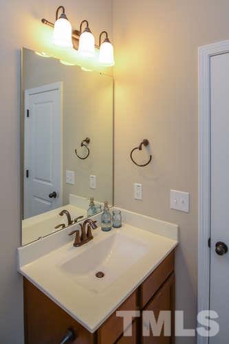 720 Wickham Ridge Road Apex, NC 27539 - Photo 11 of 21 This full bath is complete with ceramic tile flooring, a cabinet vanity, a tub/shower combination and a closet.