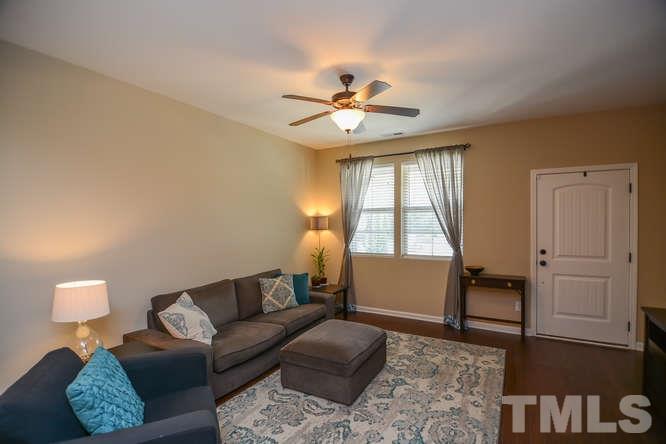 720 Wickham Ridge Road Apex, NC 27539 - Photo 3 of 21 The living room is full of natural light and makes a nice place to relax or to entertain guests. These gorgeous hardwoods run throughout the first floor.