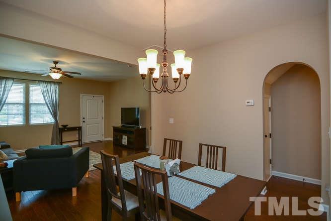 720 Wickham Ridge Road Apex, NC 27539 - Photo 21 of 21 The open floor plan is ideal for entertaining. The living room, dining room and kitchen are all open to one another. Just beyond the archway is the powder room and a storage closet.