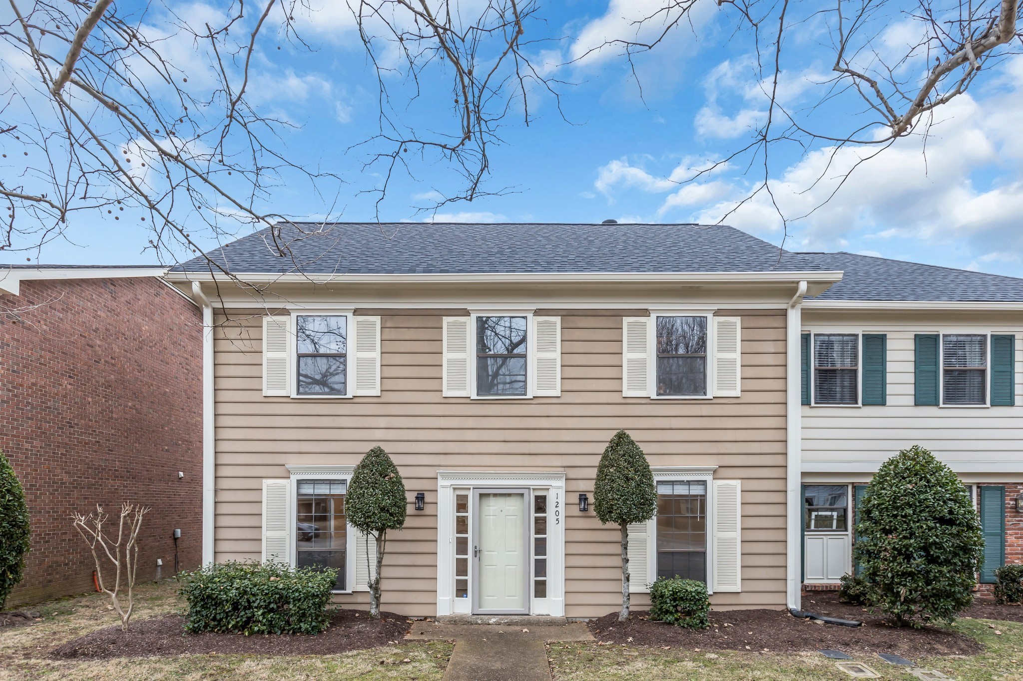 1205 General George Patton Road Nashville, TN 37221 - Photo 1 of 32 a front view of a house with garden