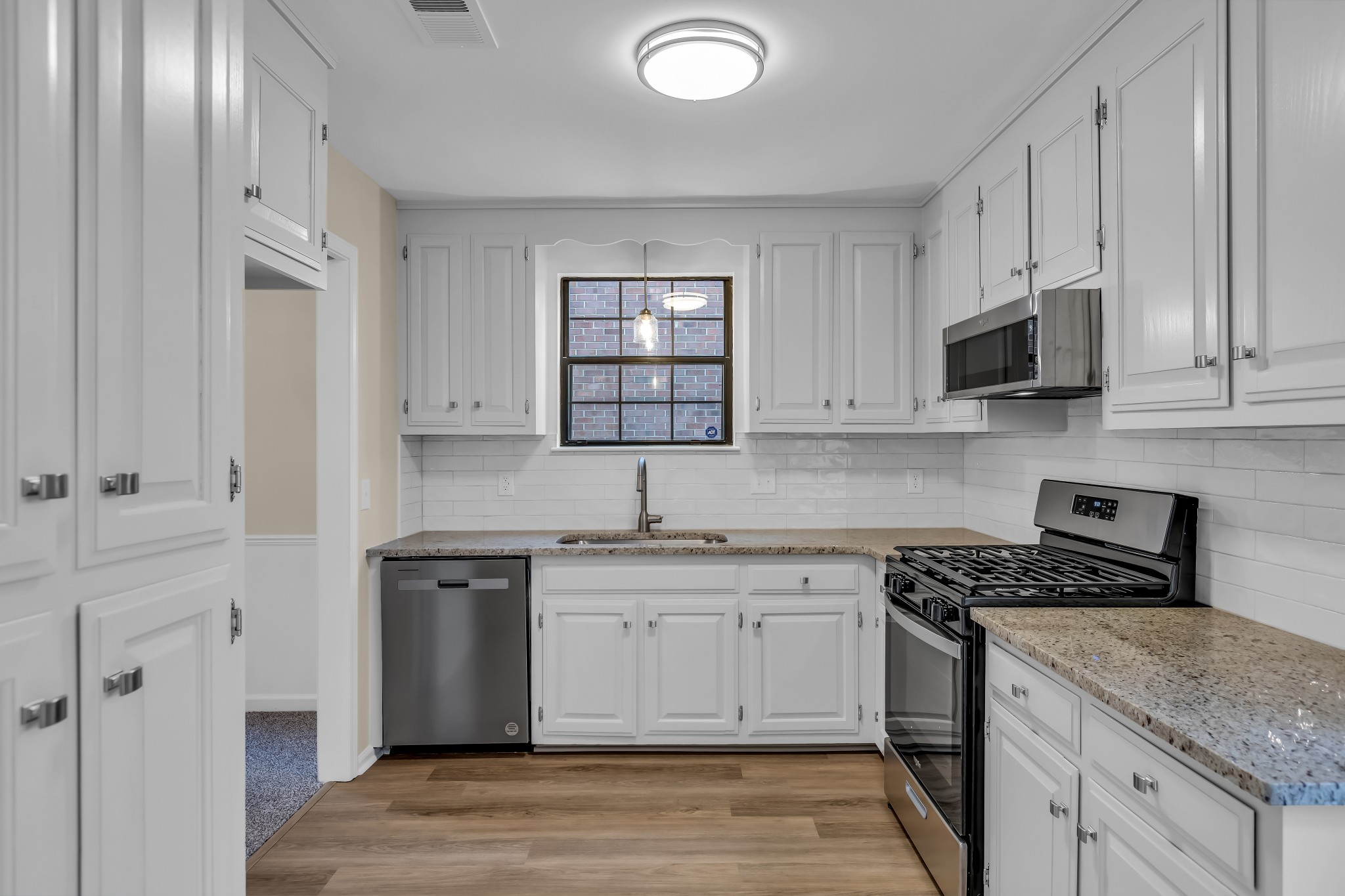 1205 General George Patton Road Nashville, TN 37221 - Photo 11 of 32 a kitchen with stainless steel appliances granite countertop a stove a sink and a microwave