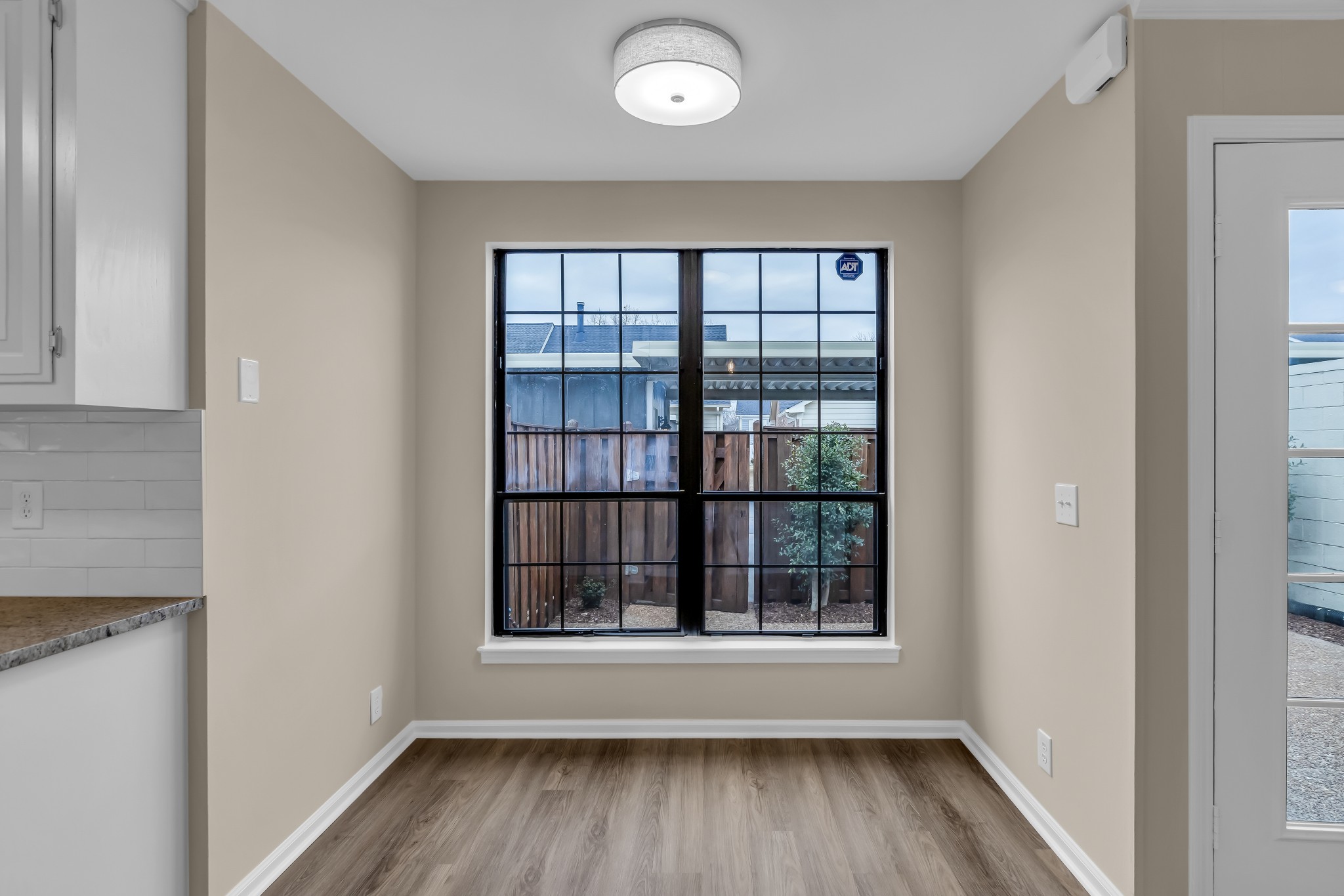 1205 General George Patton Road Nashville, TN 37221 - Photo 13 of 32 wooden floor in an empty room with a window