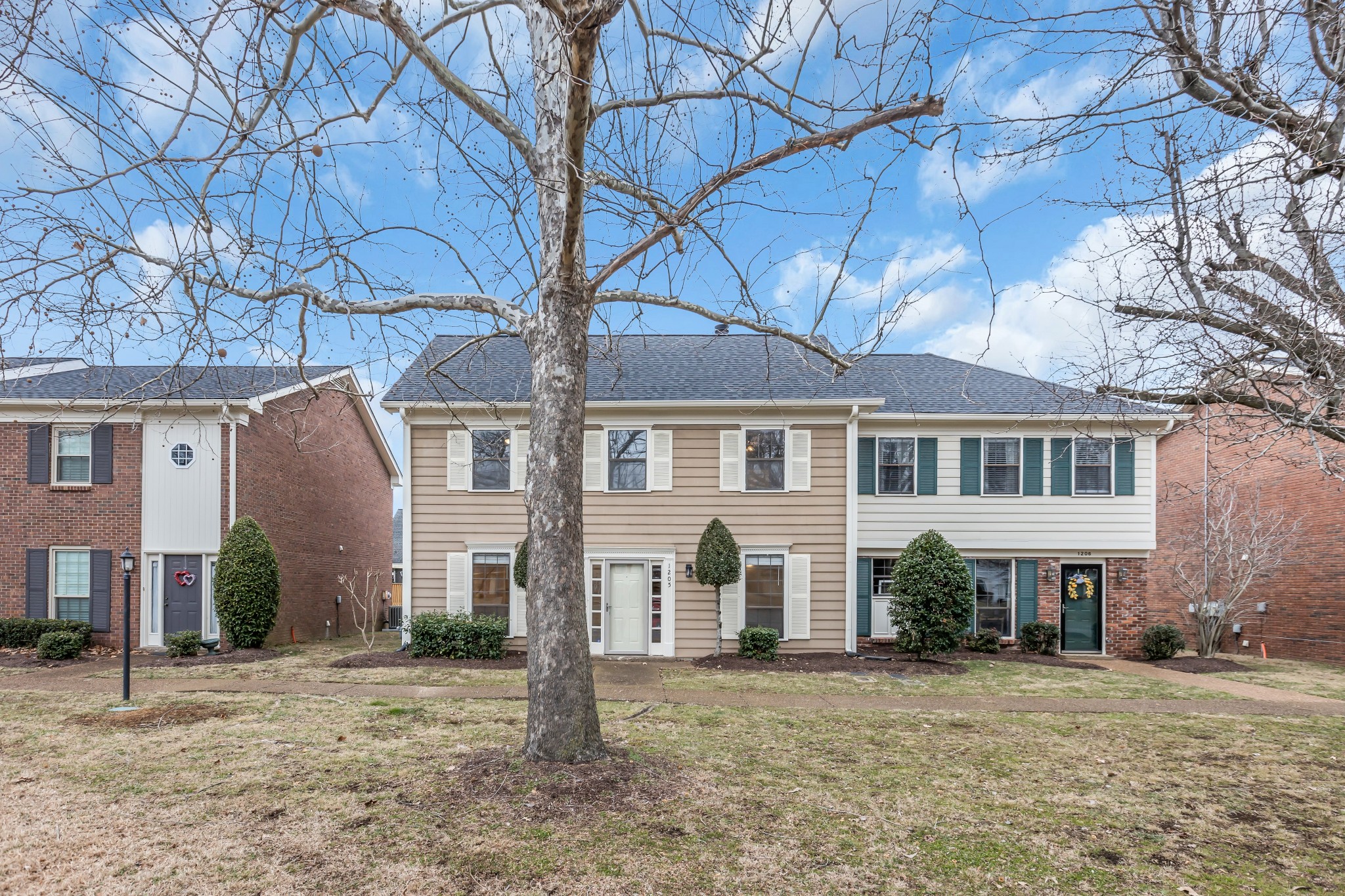 1205 General George Patton Road Nashville, TN 37221 - Photo 2 of 32 a front view of a house with a yard and garage