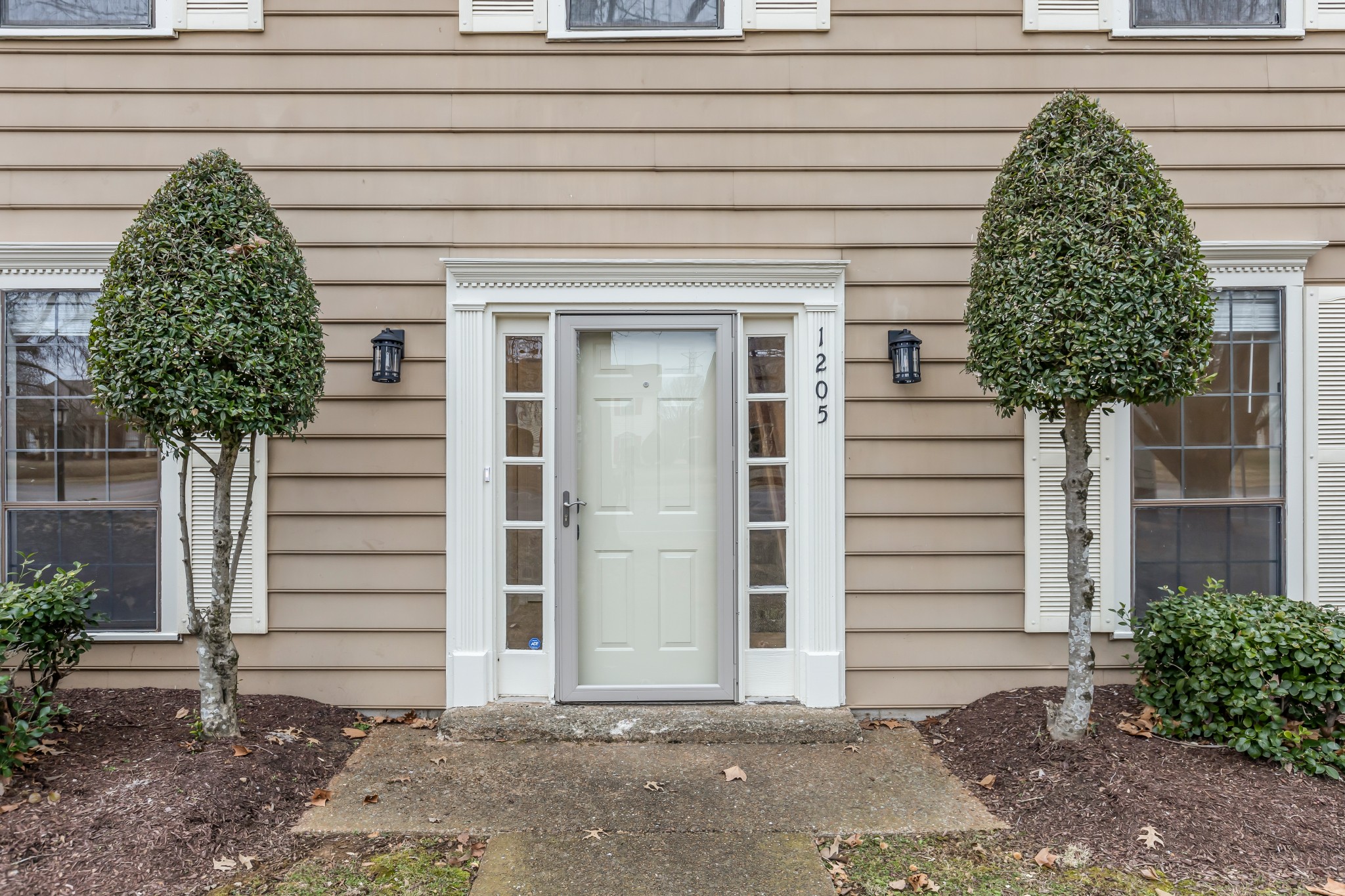 1205 General George Patton Road Nashville, TN 37221 - Photo 3 of 32 a front view of a house with a yard and garage