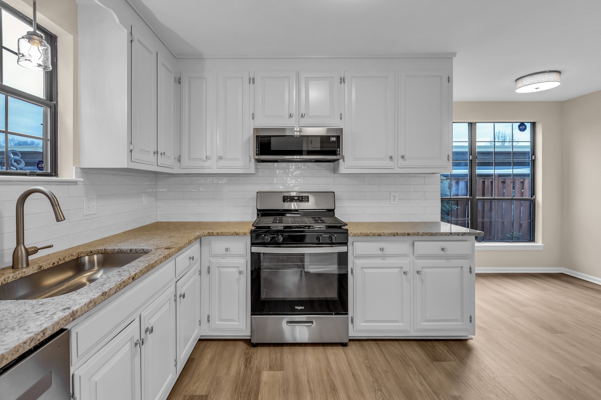 1205 General George Patton Road Nashville, TN 37221 - Photo 10 of 32 a kitchen with stainless steel appliances granite countertop a stove a sink dishwasher and a refrigerator with wooden floor
