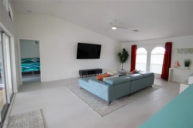 a living room with furniture and a flat screen tv