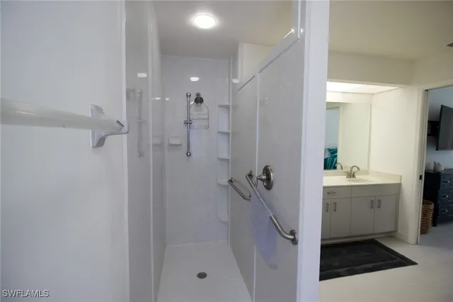 a bathroom with a shower sink and mirror