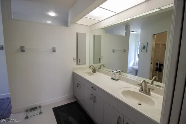 a bathroom with a double vanity sink and a mirror