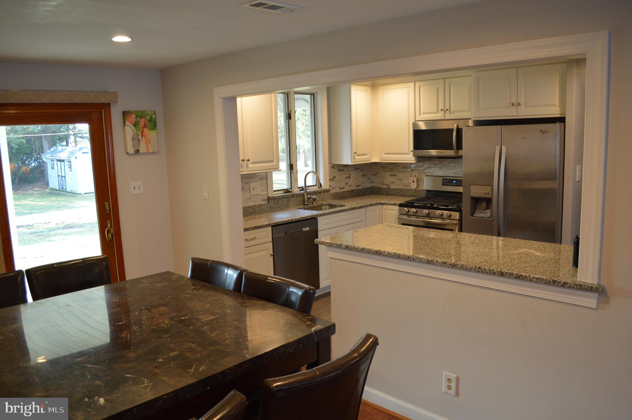 409 Cambridge Road Brookhaven, PA 19015 - Photo 9 of 31 view of dining room open to kit, rear slider