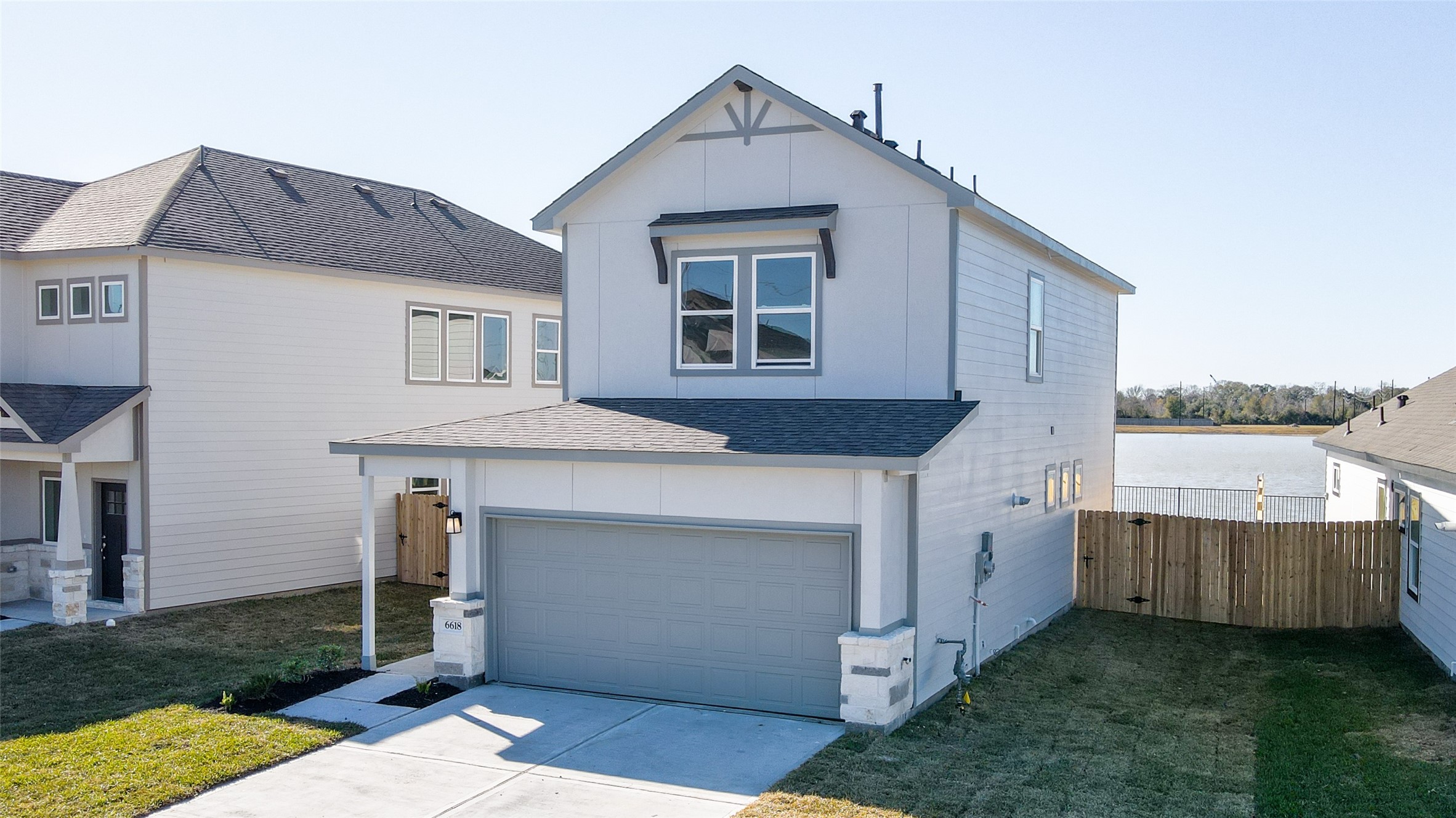 6618 Escondido Drive Rosharon, TX 77583 - Photo 2 of 31 Modern two-story home with a clean exterior, featuring a two-car garage and a fenced backyard. Located near a body of water, offering potential scenic views. Ideal for families seeking a contemporary design.