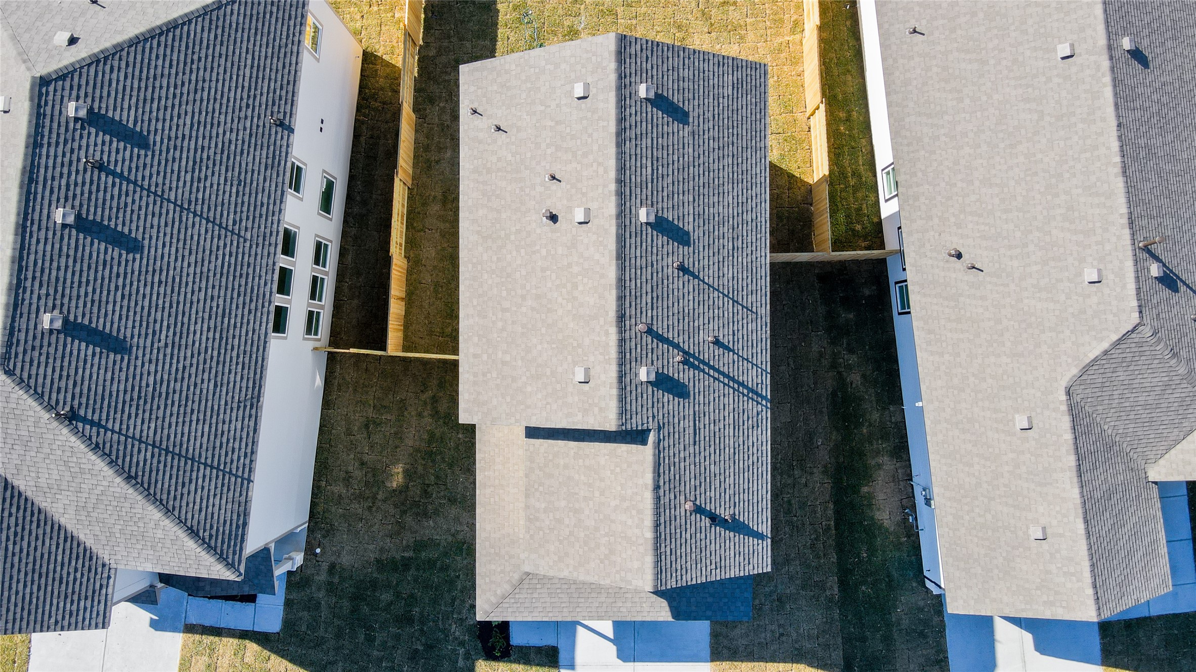 6618 Escondido Drive Rosharon, TX 77583 - Photo 28 of 31 This aerial view shows a row of modern homes with dark roofs and fenced yards, offering a scenic view of your lake.