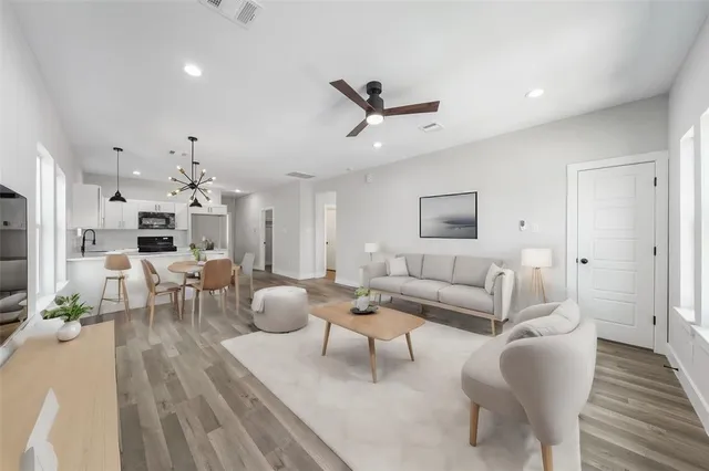 a living room with furniture and a wooden floor