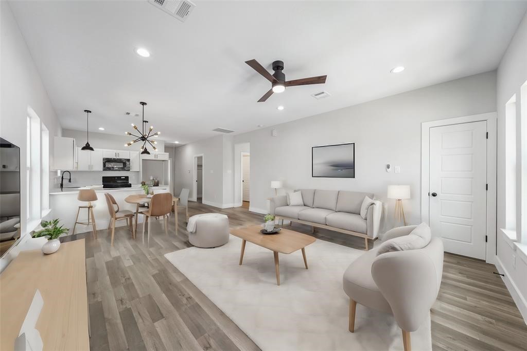 a living room with furniture and a wooden floor
