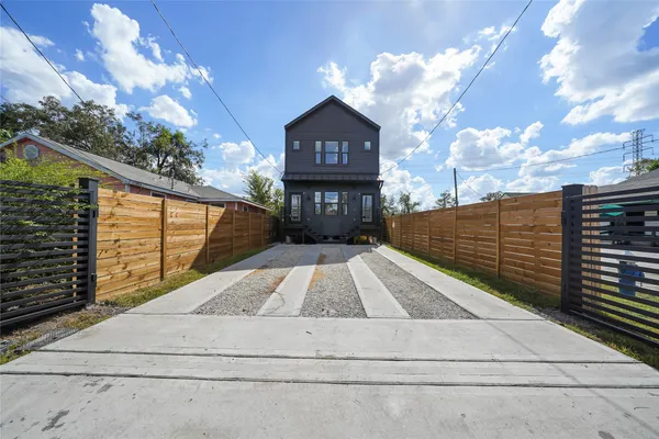 a kitchen with stainless steel appliances kitchen island a refrigerator and a wooden floor