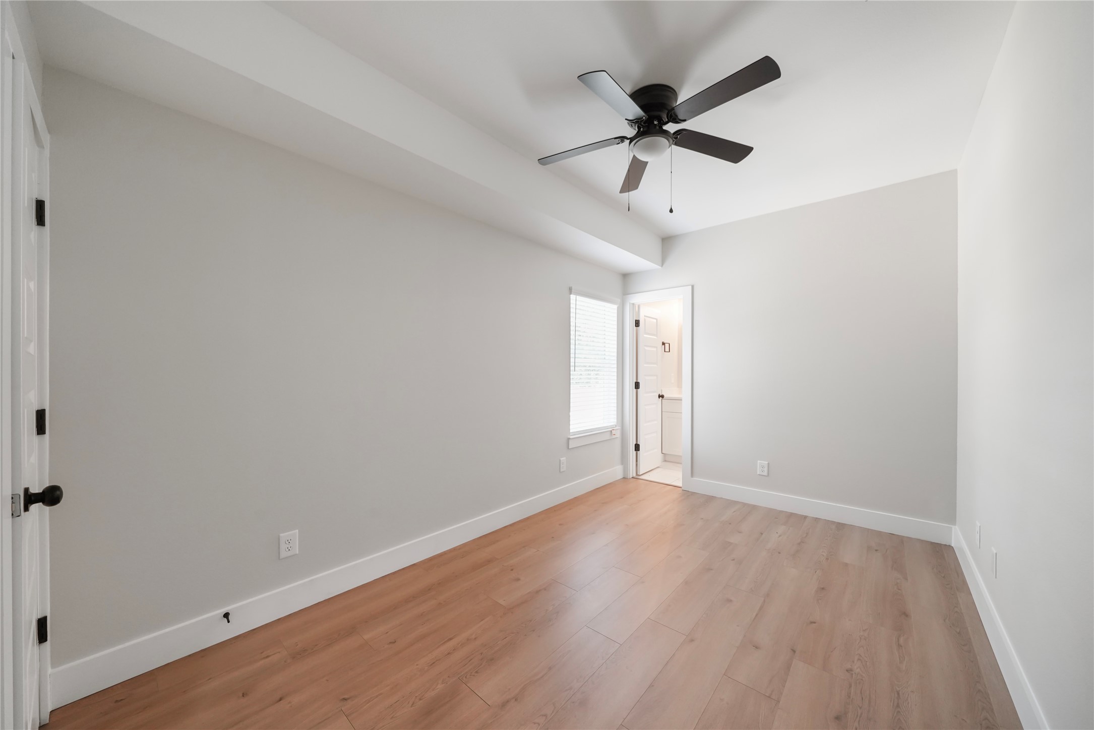 402 East 37th Street, Unit A Houston, TX 77018 - Photo 6 of 10 an empty room with wooden floor and ceiling fan