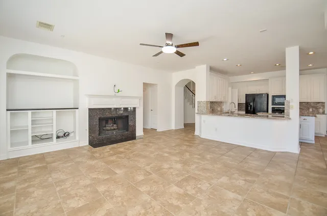 a bathroom with a bathtub shower sink vanity mirror and toilet