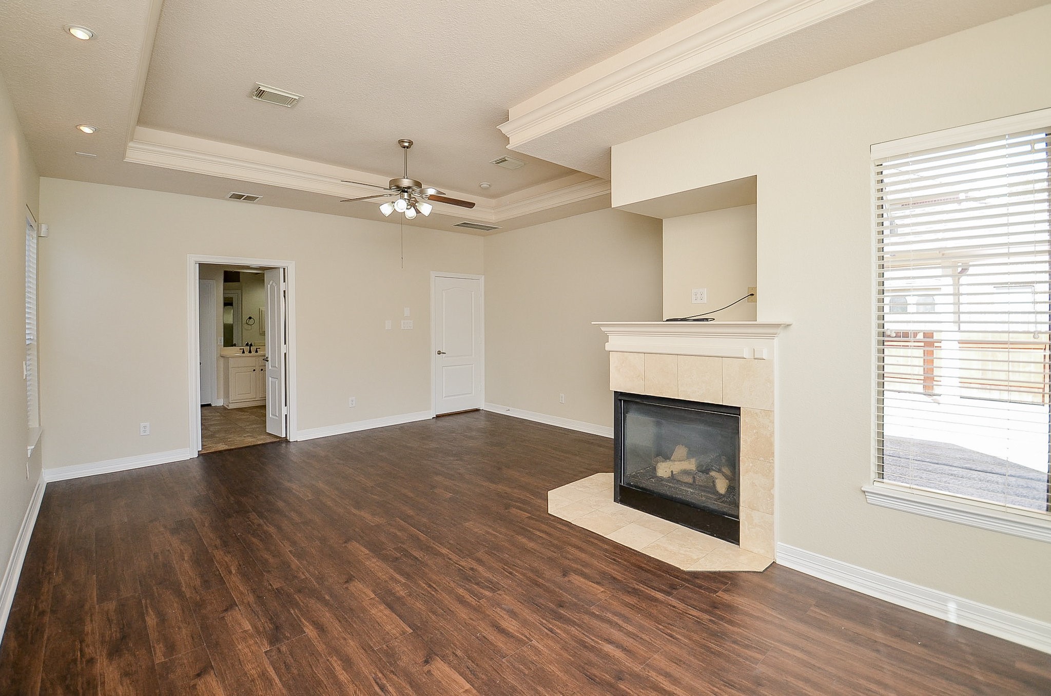 5615 Bent Arbor Lane Katy, TX 77450 - Photo 18 of 42 a view of an empty room with wooden floor fireplace and a window
