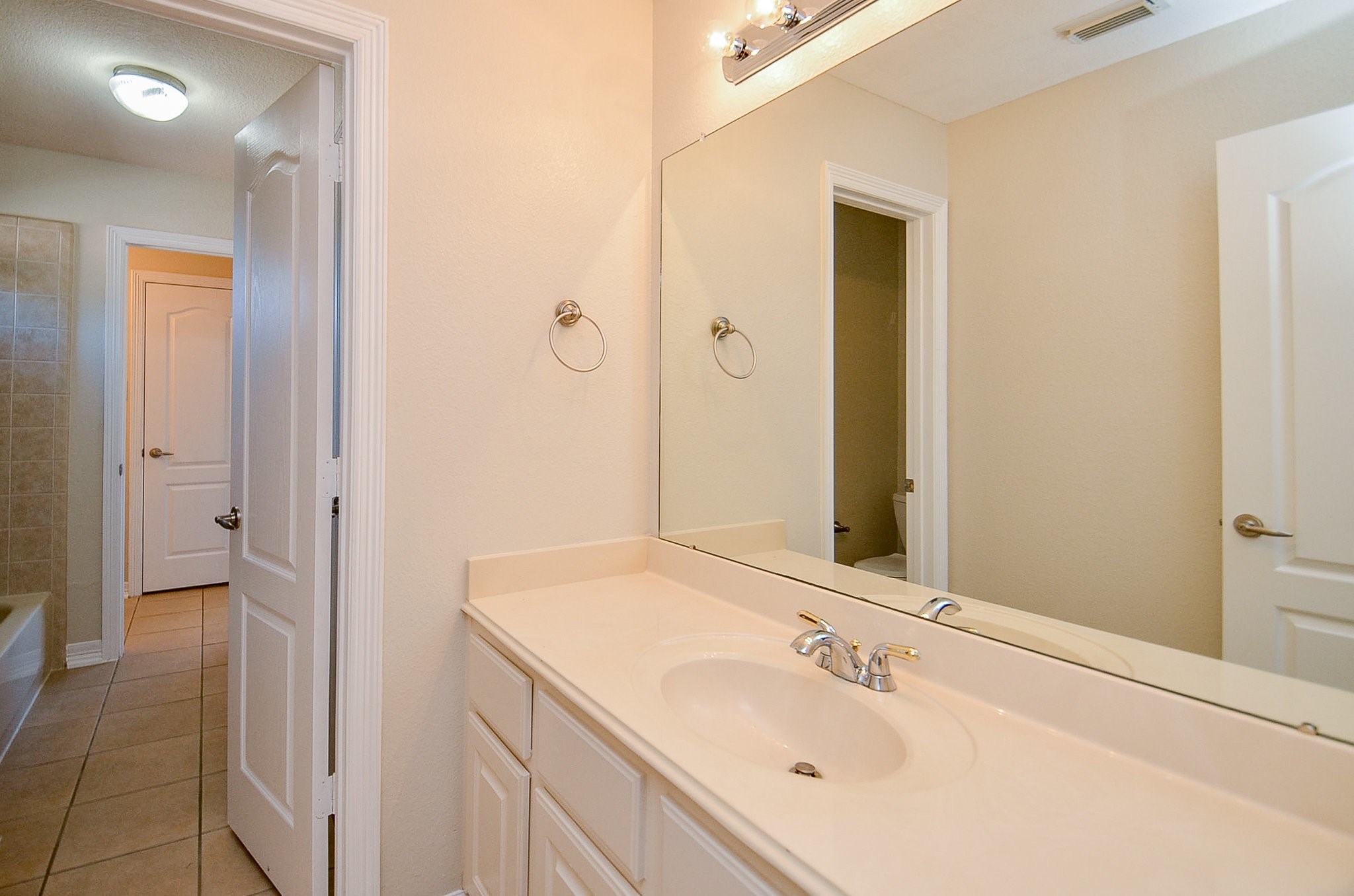 5615 Bent Arbor Lane Katy, TX 77450 - Photo 27 of 42 a bathroom with a sink and a mirror