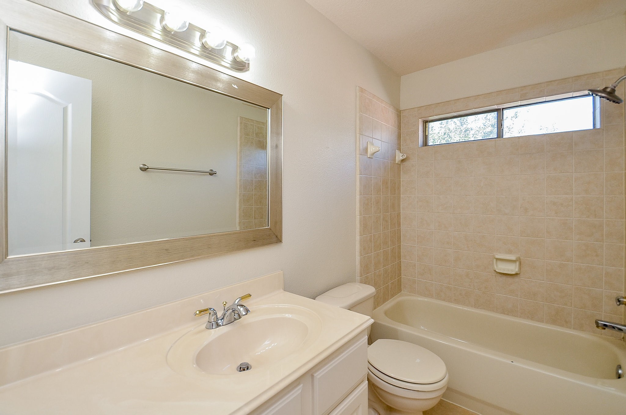 5615 Bent Arbor Lane Katy, TX 77450 - Photo 29 of 42 a bathroom with a bathtub shower sink vanity mirror and toilet