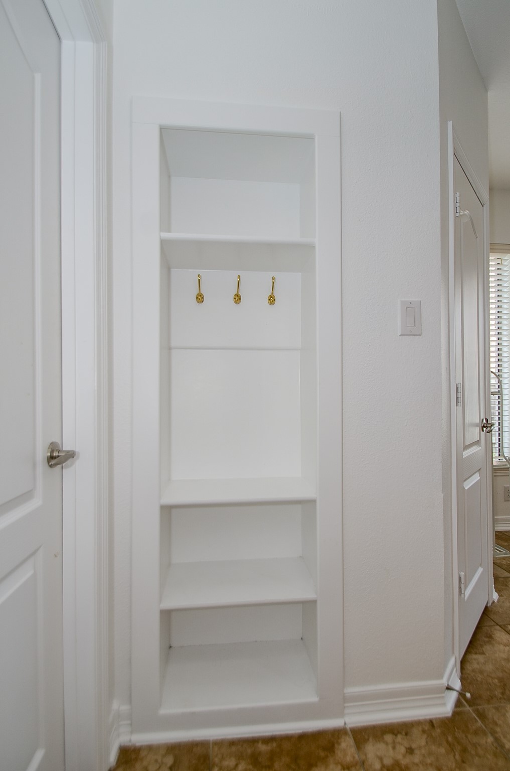 5615 Bent Arbor Lane Katy, TX 77450 - Photo 30 of 42 A miniature "mud" room near the utility room and kitchen to house the essential items on your way out the door.