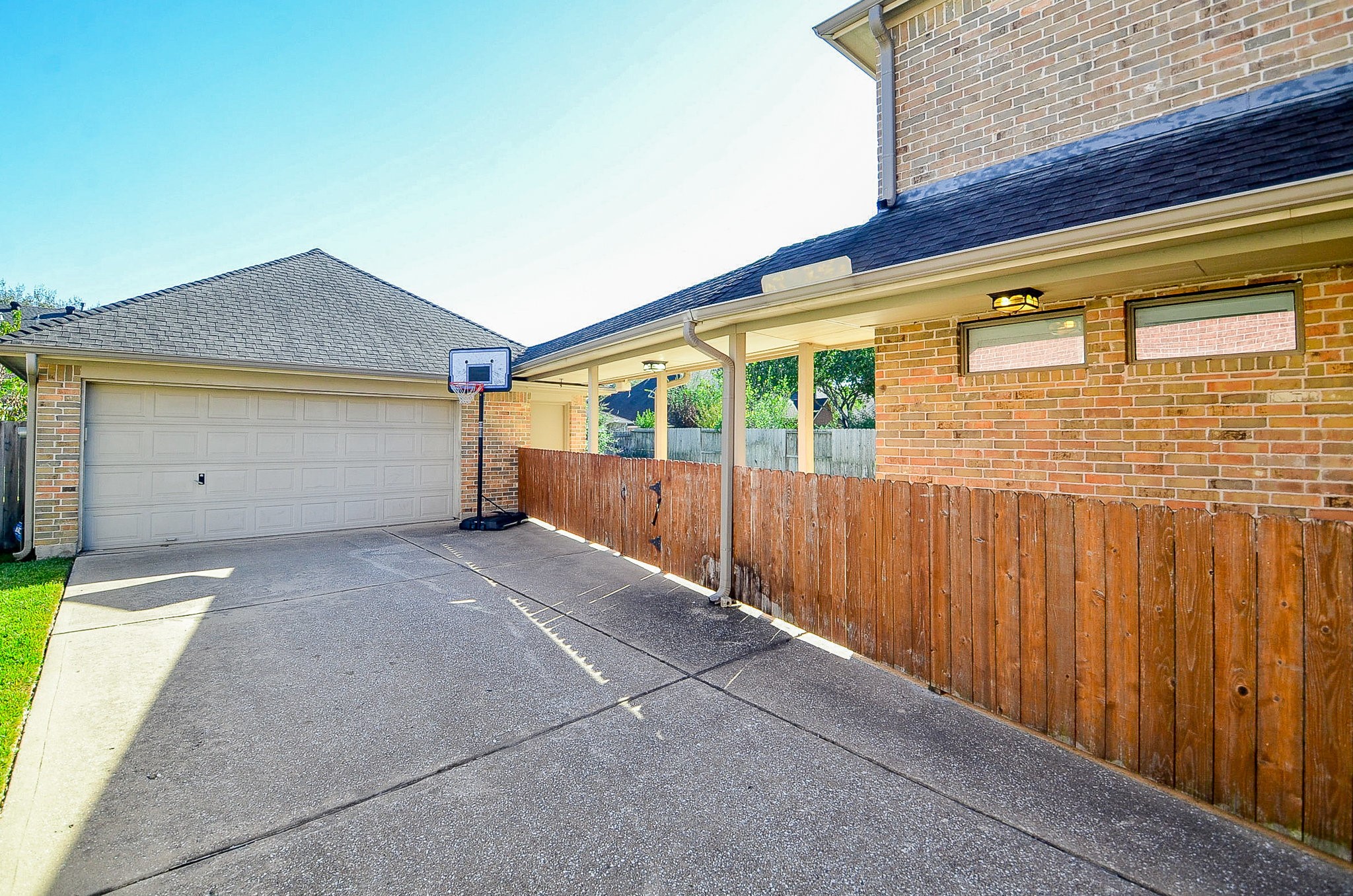 5615 Bent Arbor Lane Katy, TX 77450 - Photo 37 of 42 The 2 car detached garage is set back off the street, behind the house. It has a 10 ft extension on the back side for additional storage or workspace. There is even an area for your exercise equipment with a full length mirror to critique your workout.