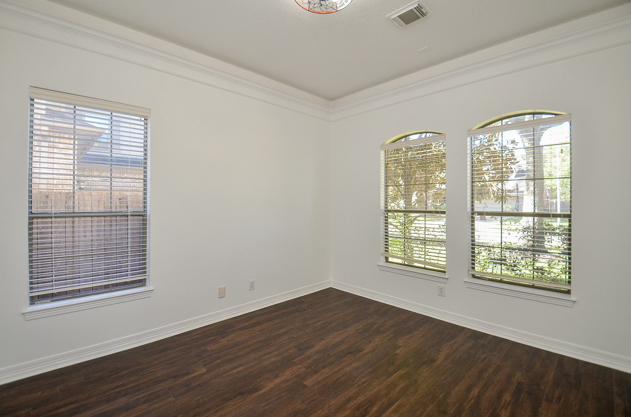 5615 Bent Arbor Lane Katy, TX 77450 - Photo 6 of 42 a view of an empty room with wooden floor and a window