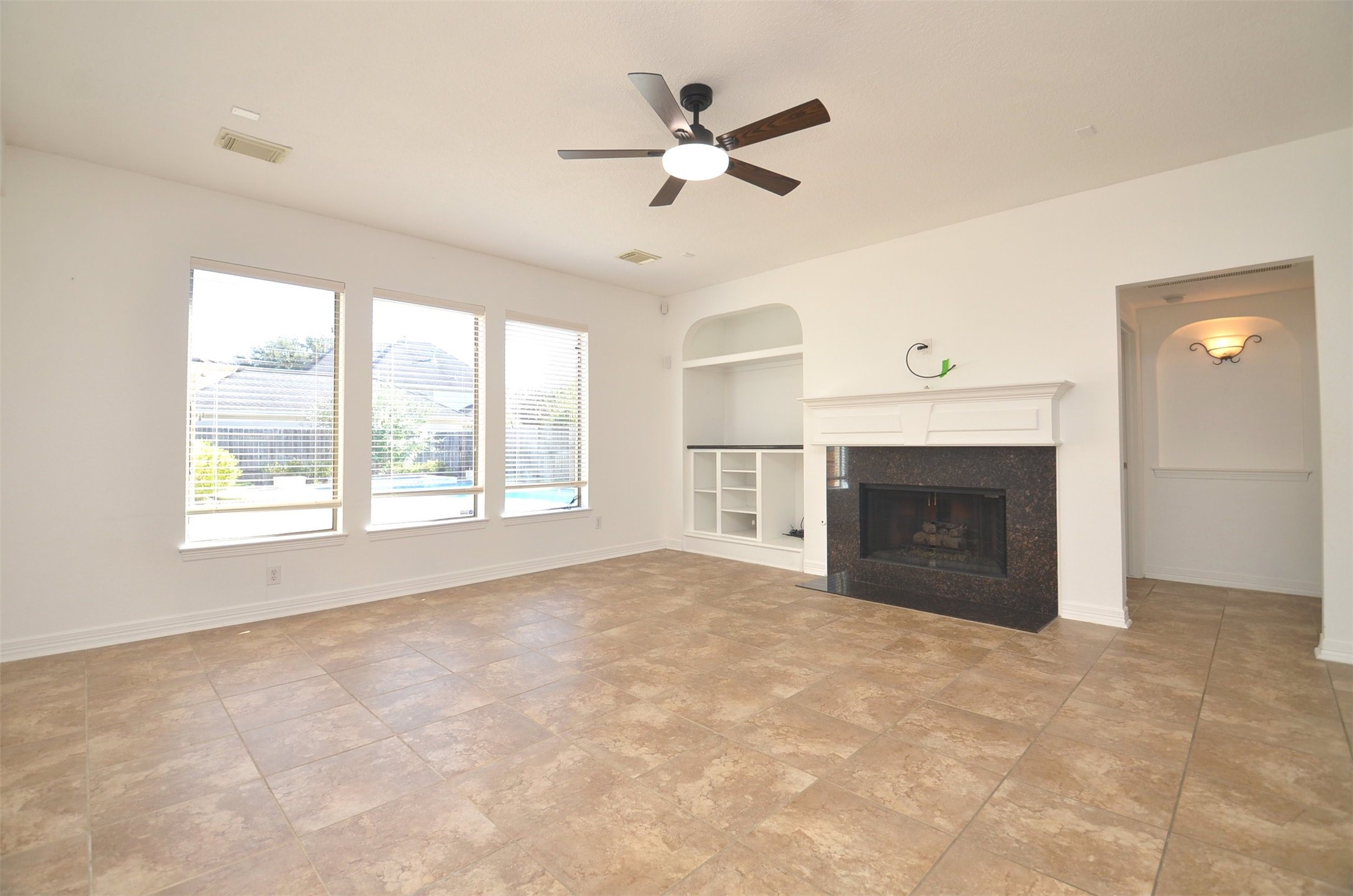 5615 Bent Arbor Lane Katy, TX 77450 - Photo 10 of 42 an empty room with windows and fireplace
