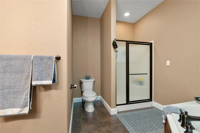a bathroom with a toilet and a shower