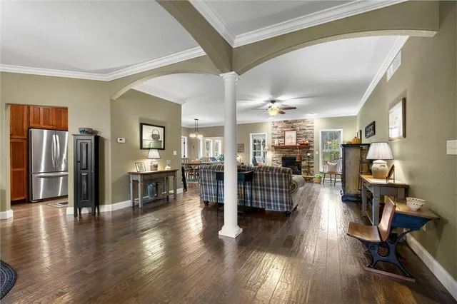 a room with lots of wooden furniture and a large window
