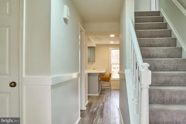 a view of entryway and hall with wooden floor