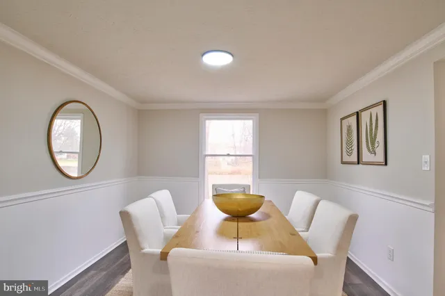 a view of a dining room with furniture and a large window