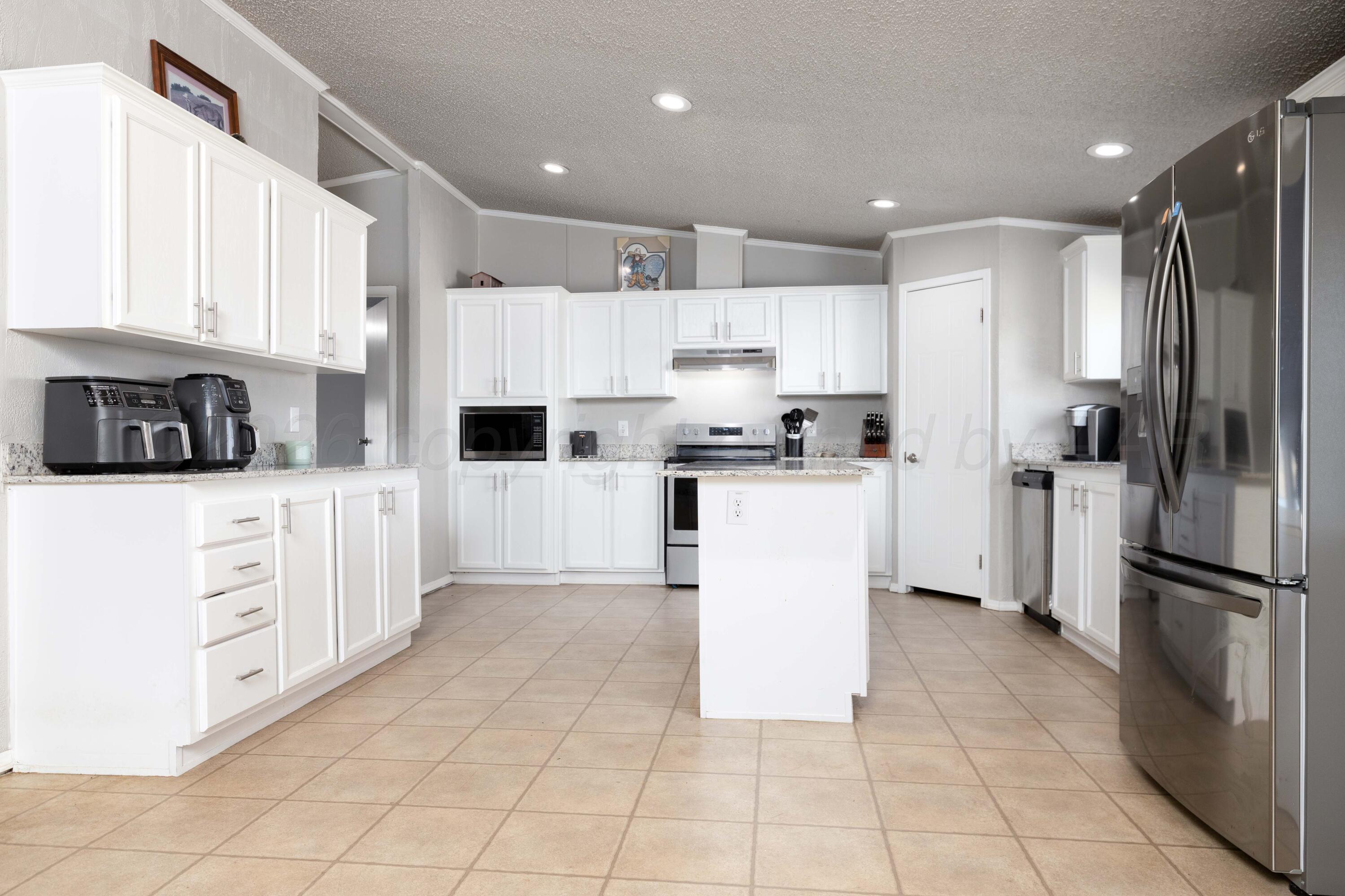 5410 Tranquility Road Amarillo, TX 79118 - Photo 13 of 37 a kitchen with cabinets and stainless steel appliances