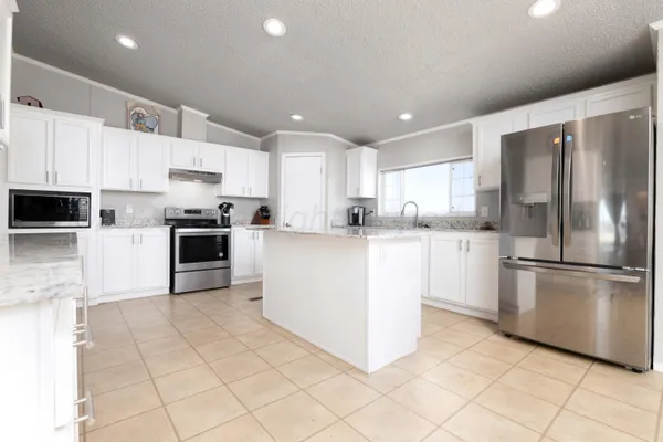 a view of kitchen with furniture and ceiling fan