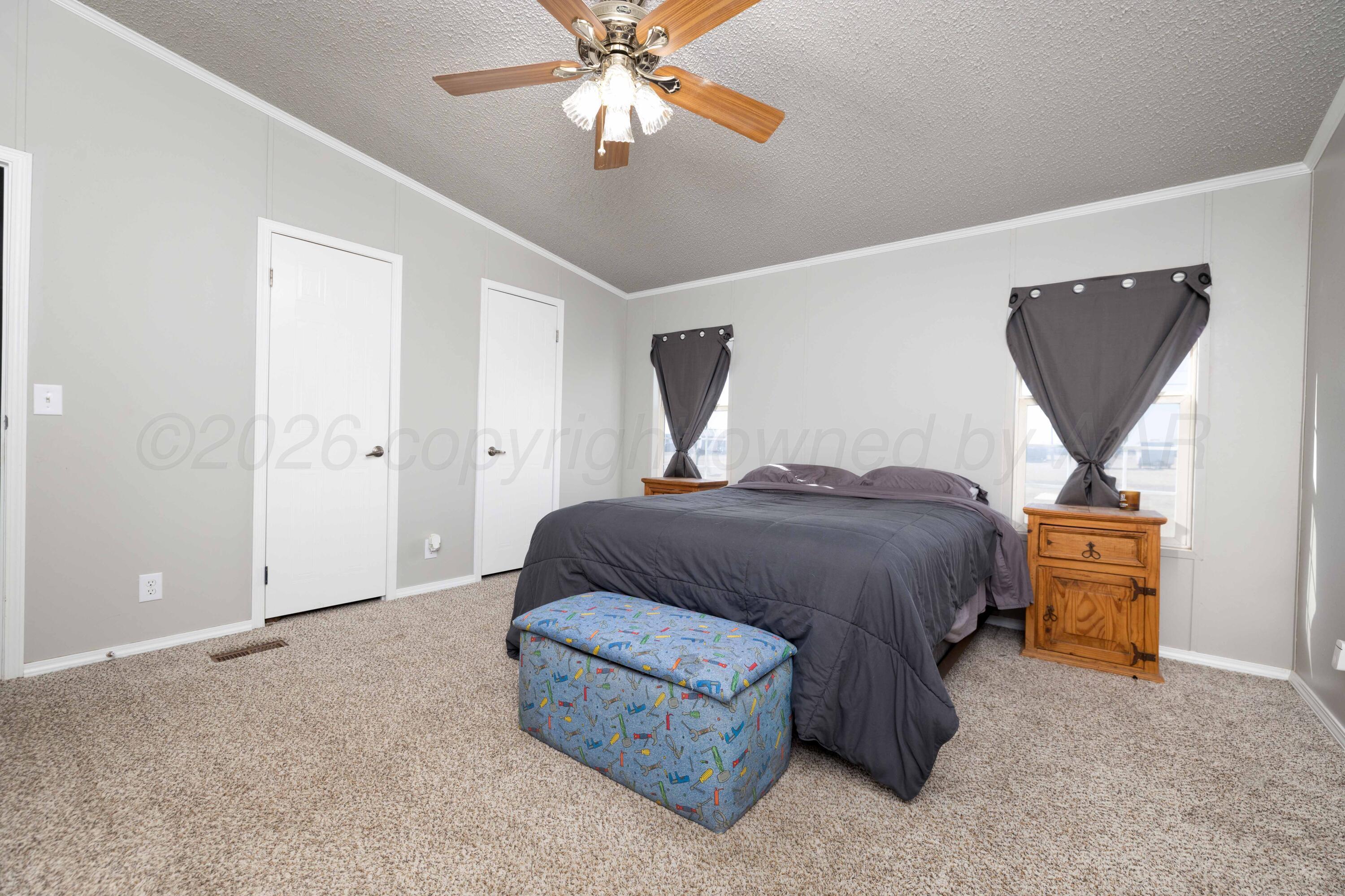 5410 Tranquility Road Amarillo, TX 79118 - Photo 19 of 37 a bedroom with a bed and lamp