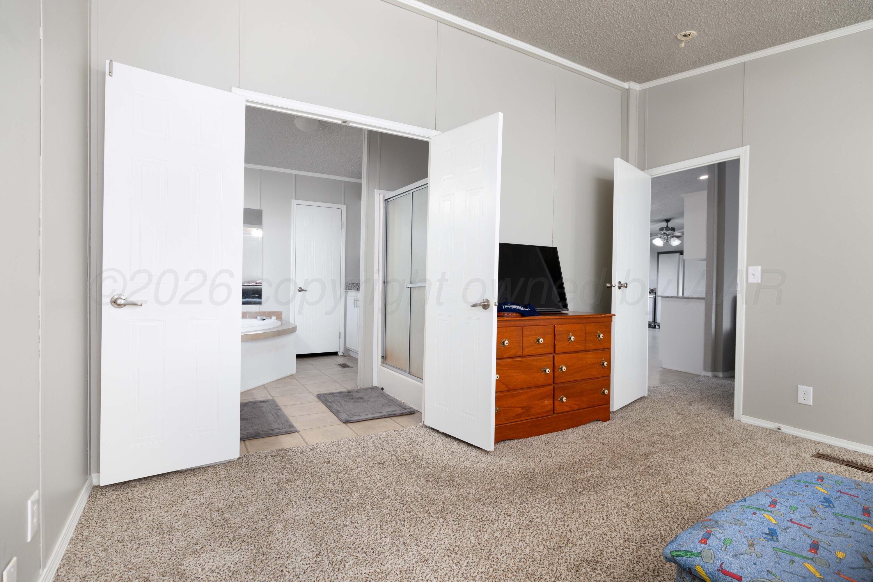5410 Tranquility Road Amarillo, TX 79118 - Photo 20 of 37 wooden floor with a cabinet and a flat screen tv