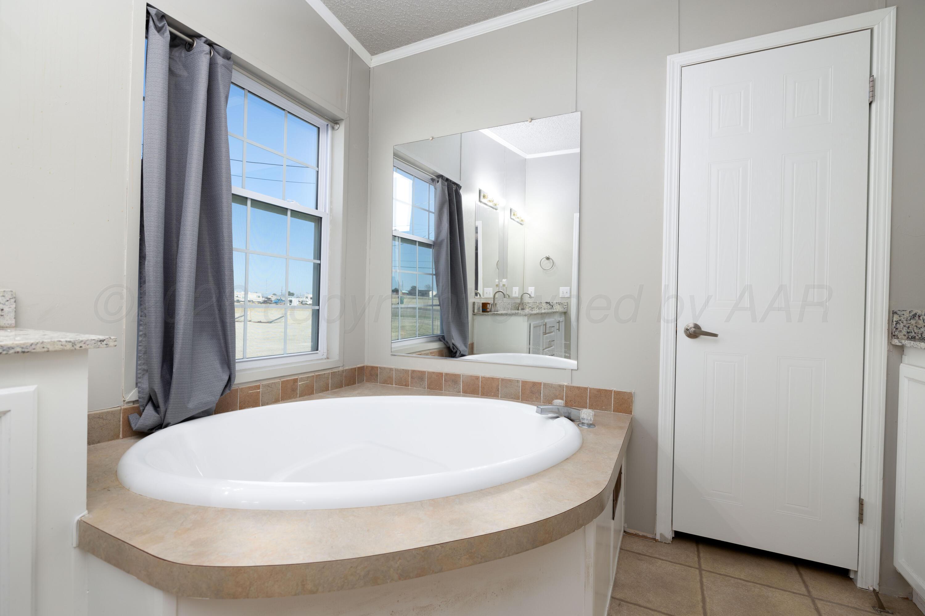 5410 Tranquility Road Amarillo, TX 79118 - Photo 25 of 37 a bathroom with a sink and a mirror