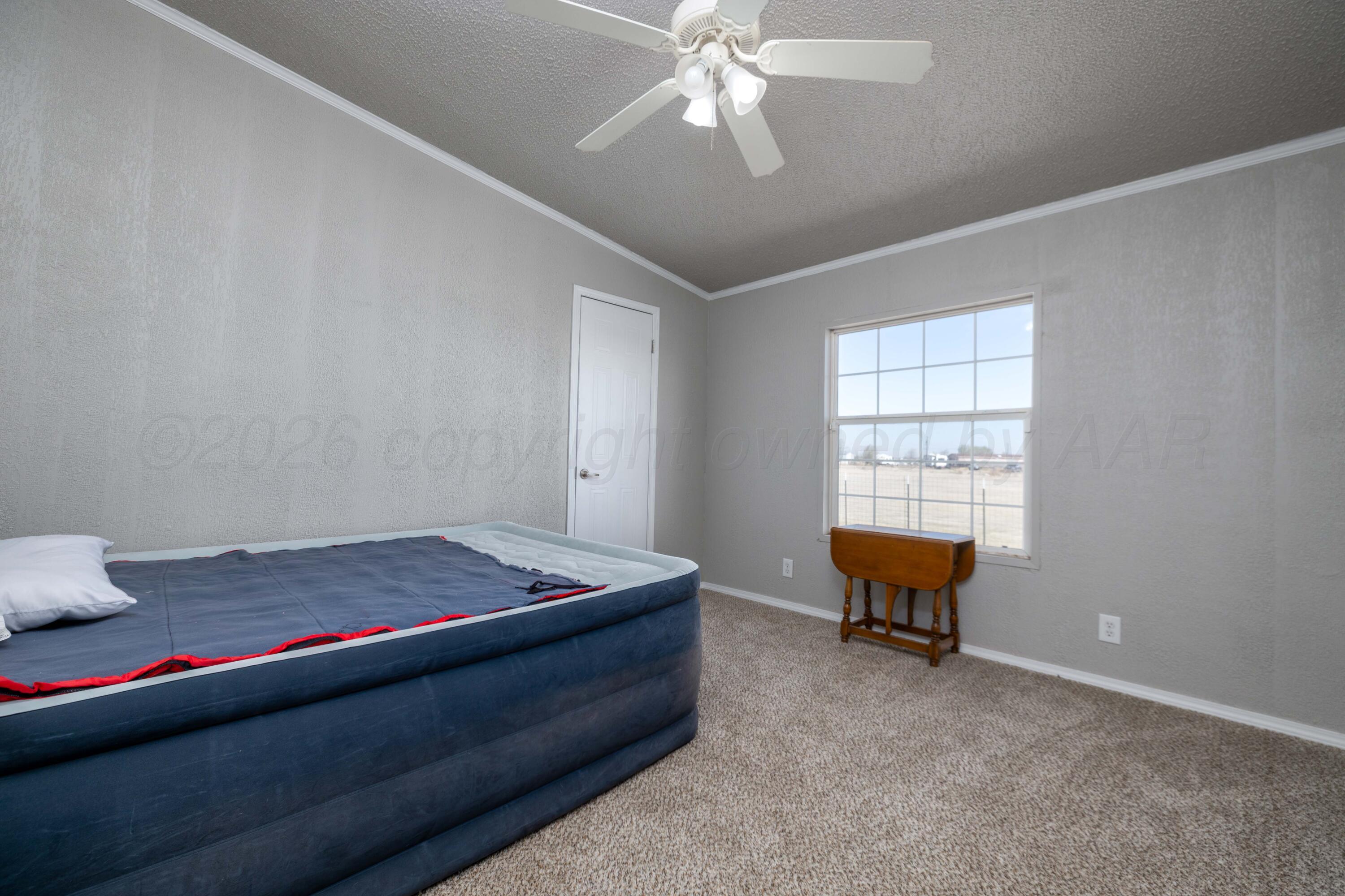 5410 Tranquility Road Amarillo, TX 79118 - Photo 28 of 37 a bedroom with a bed and window