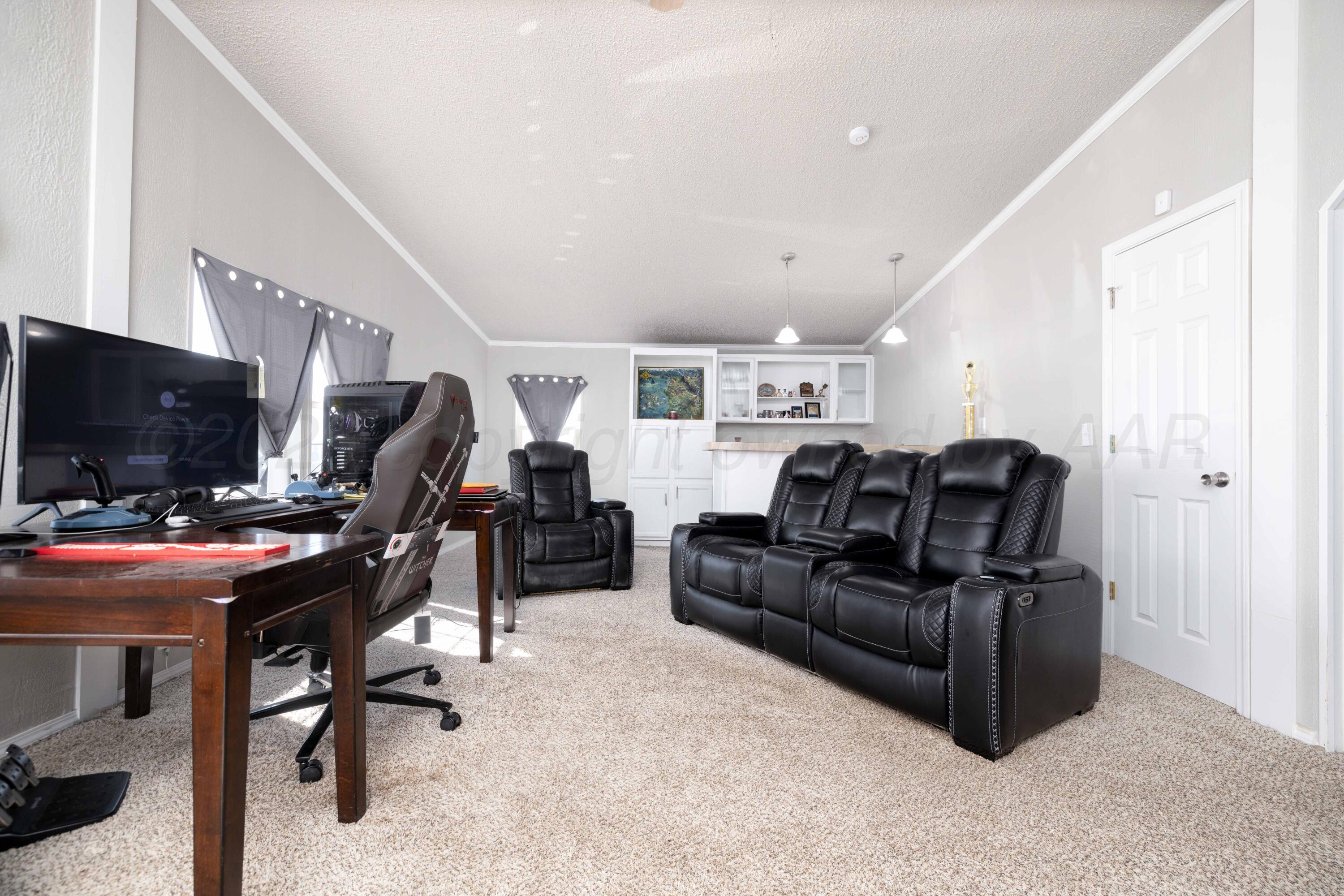 5410 Tranquility Road Amarillo, TX 79118 - Photo 34 of 37 a living room with furniture a flat screen tv and a window