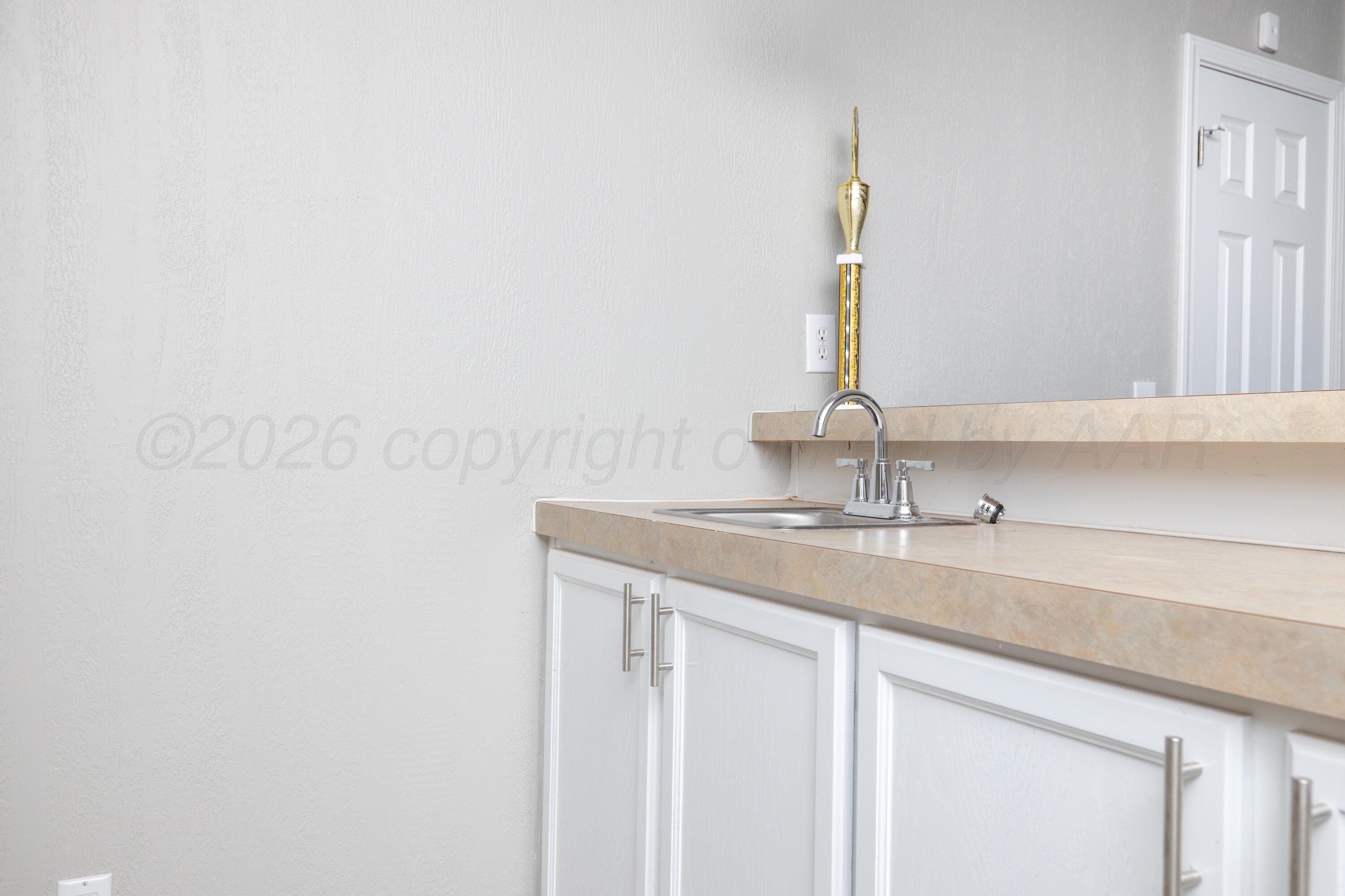 5410 Tranquility Road Amarillo, TX 79118 - Photo 36 of 37 a bathroom with a sink and a mirror