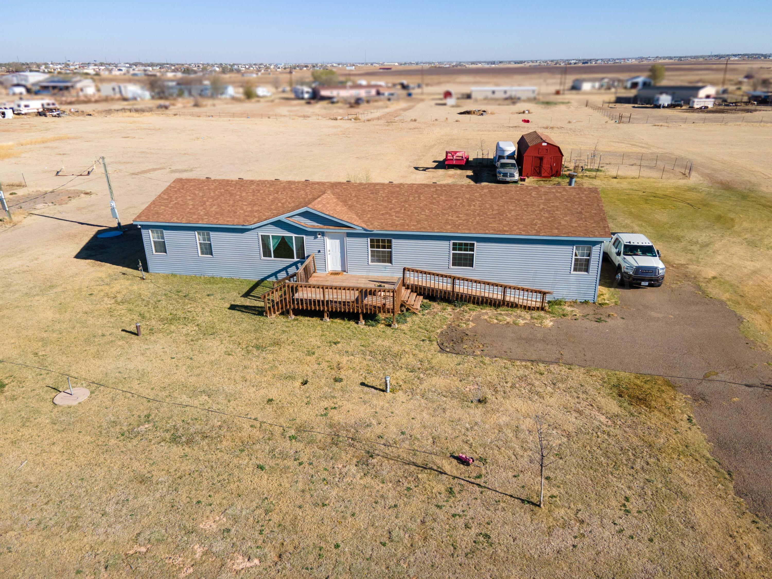 5410 Tranquility Road Amarillo, TX 79118 - Photo 4 of 37 a view of a lake with a building in the background