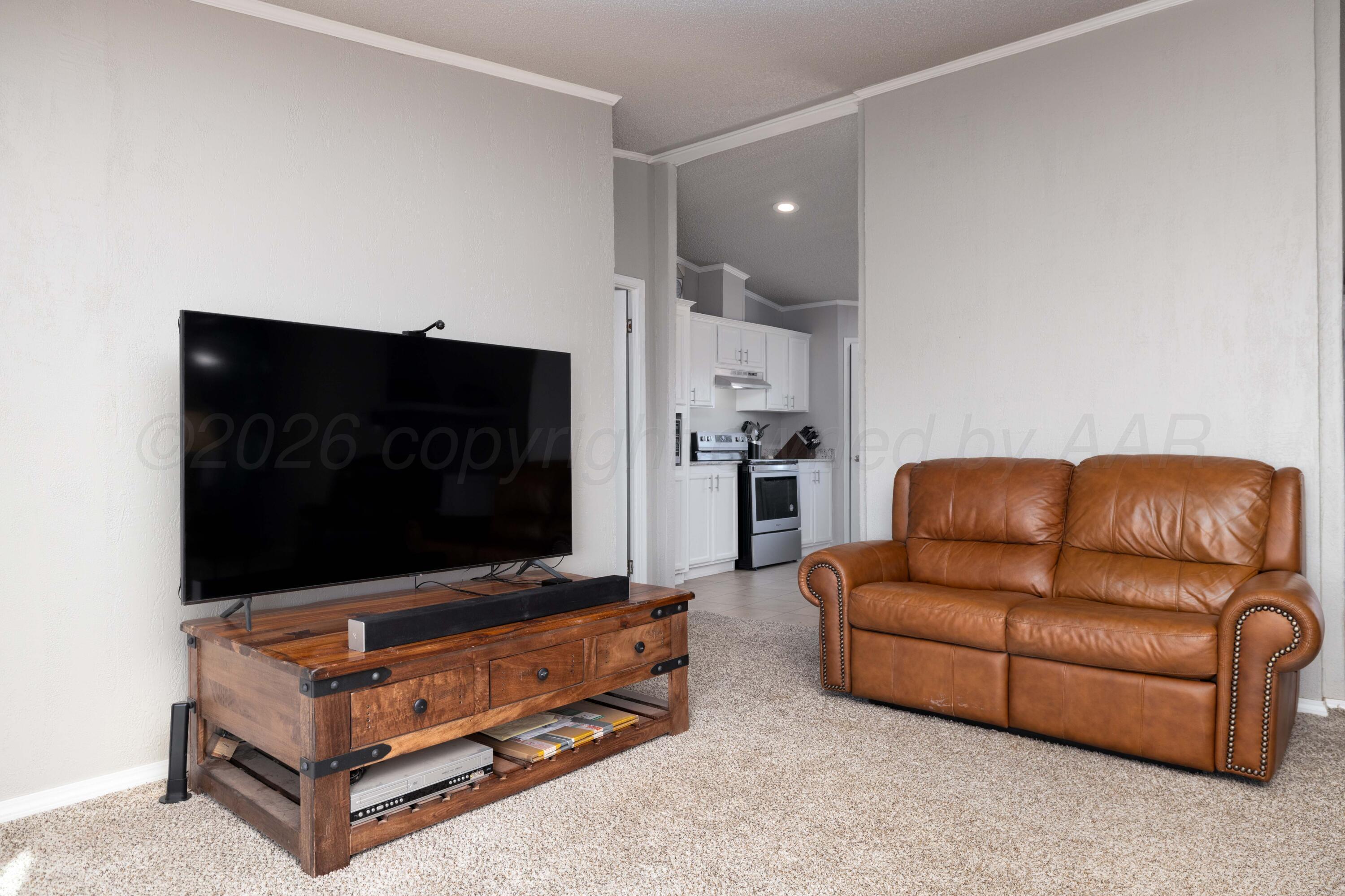5410 Tranquility Road Amarillo, TX 79118 - Photo 10 of 37 a living room with furniture and a flat screen tv
