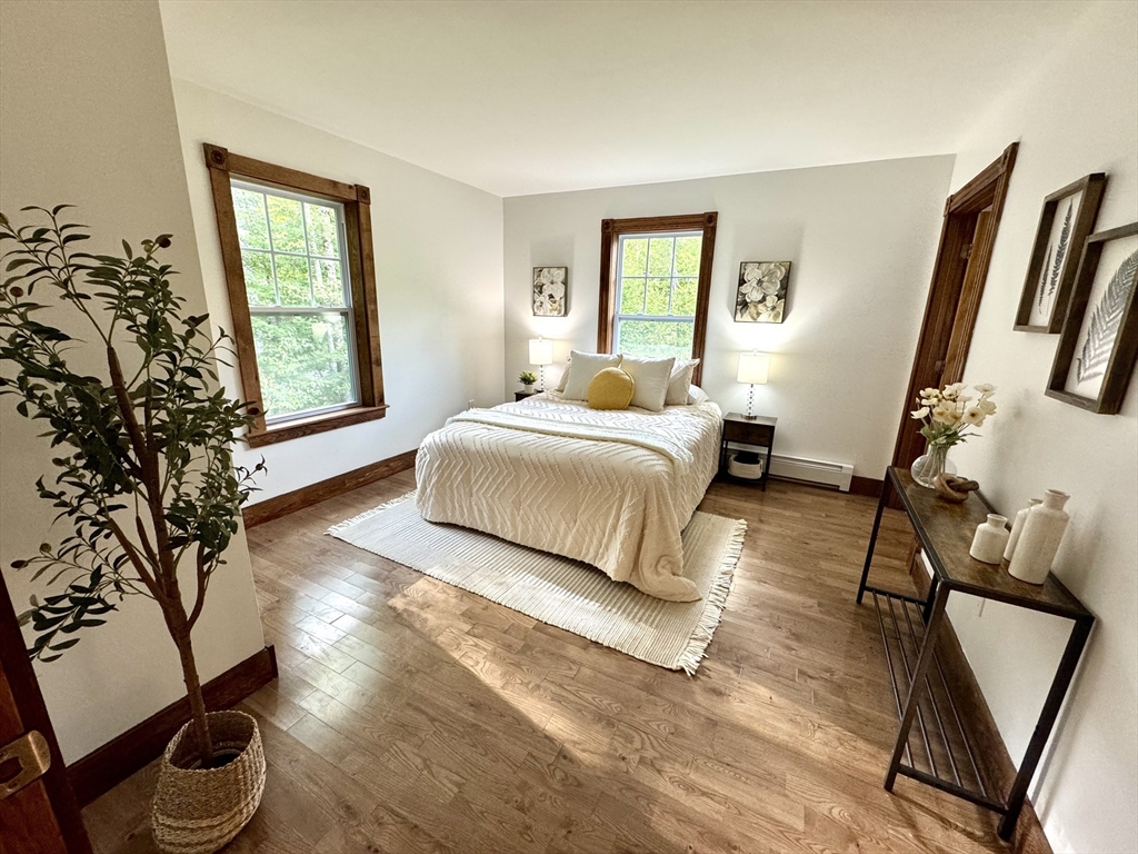 27 Popple Camp Road Petersham, MA 01366 - Photo 30 of 42 a bedroom with a bed and wooden floor