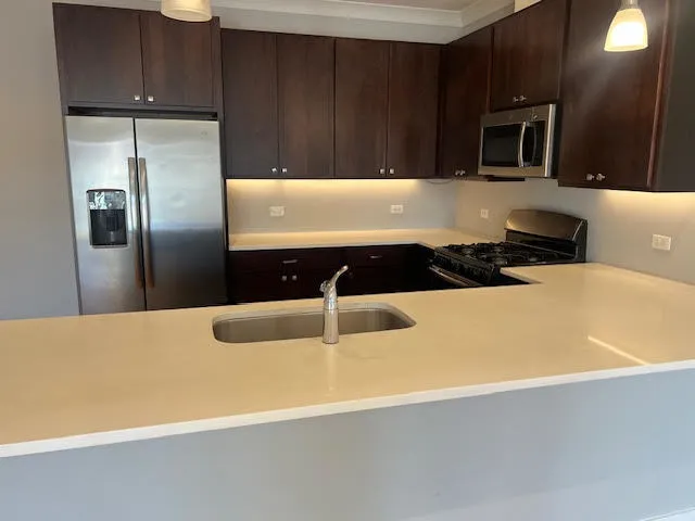 a kitchen with a refrigerator and a stove top oven