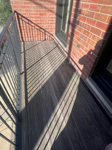 a view of balcony with wooden floor