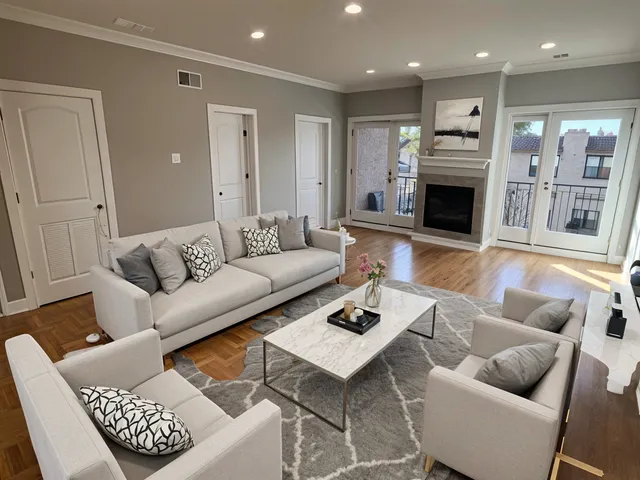 a living room with furniture a wooden floor and a fireplace