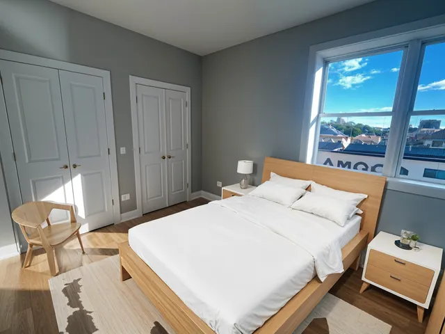 a bed room with a bed and a chair