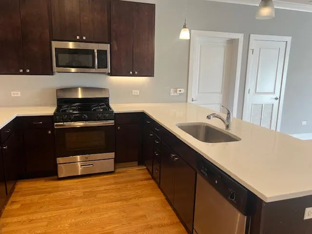 a kitchen with a sink and a stove top oven