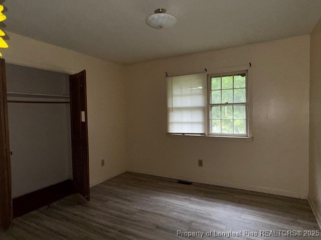 102 Little Street Rockingham, NC 28379 - Photo 16 of 29 an empty room with wooden floor and windows