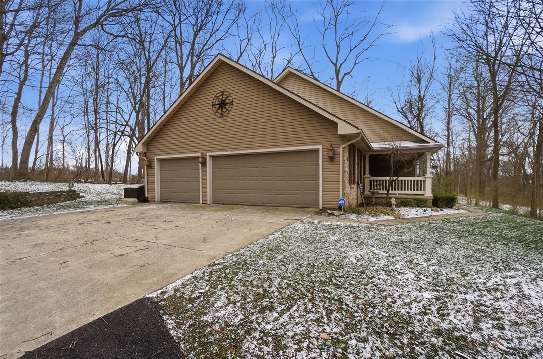 5300 Brookshire Lane Springfield, OH 45502 - Photo 53 of 56 This charming residence features a two-car garage and a welcoming front porch, nestled among mature trees.
